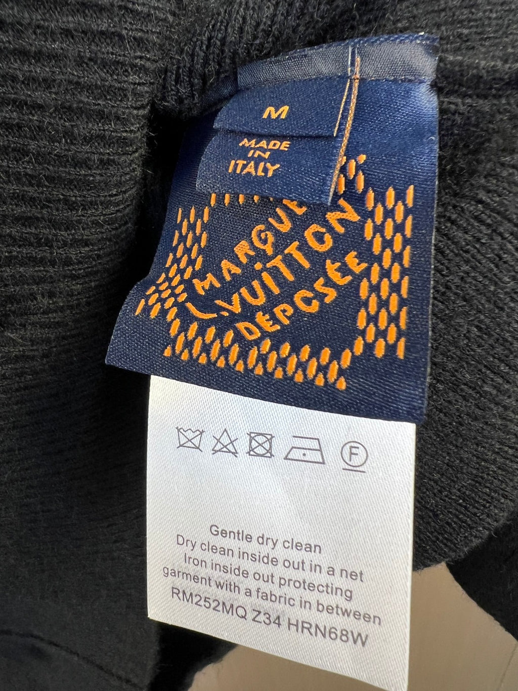 Sweater care label with Made in Italy text and cleaning instructions