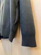 Dark-tone knit sweater sleeve and cuff detail