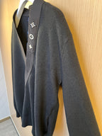 Side view of dark knit sweater with embroidered Louis Vuitton crest patches