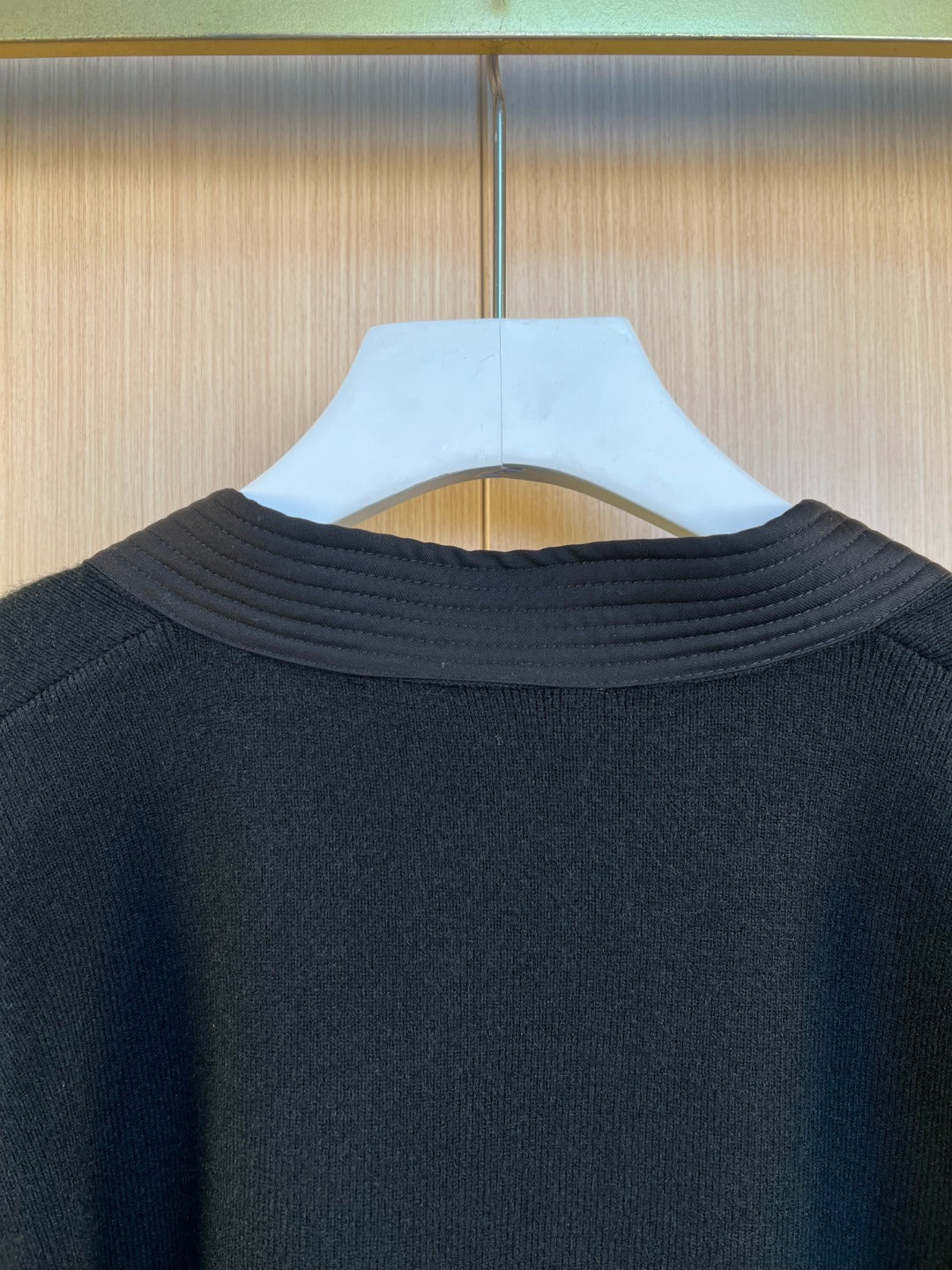 Sweater neckline close-up with ribbed collar in dark knit fabric
