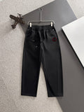 Black Gucci pants with elastic waistband, drawstring, and front slash pockets