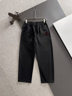Black Gucci pants with elastic waistband, drawstring, and front slash pockets