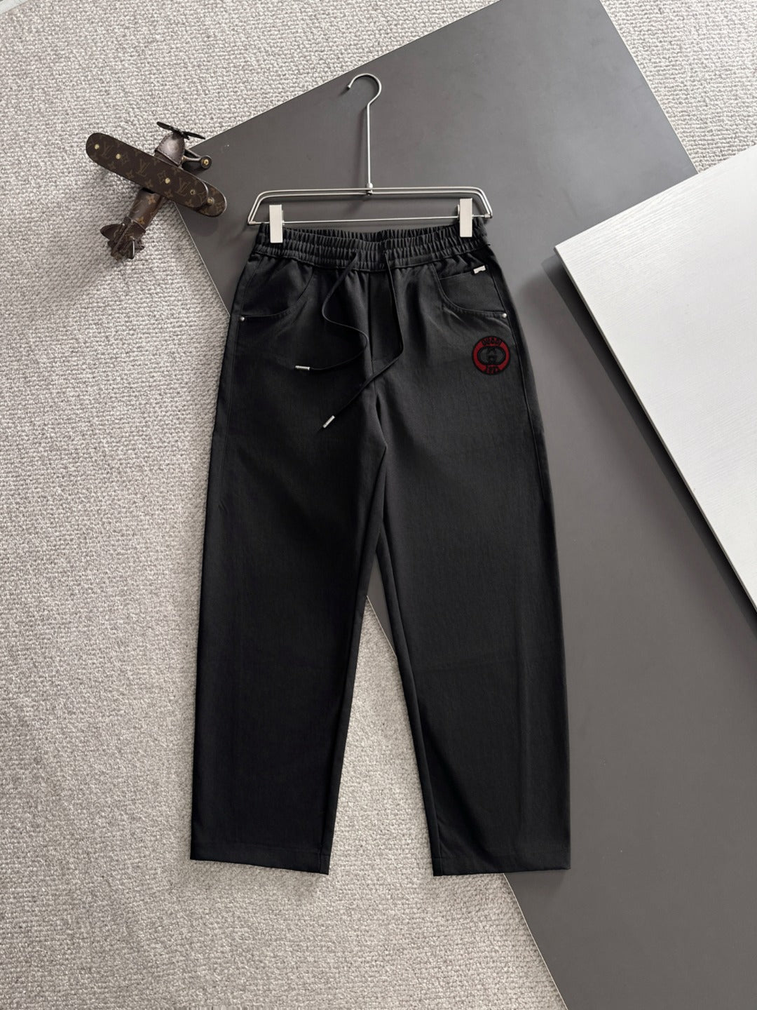 Black Gucci pants with elastic waistband, drawstring, and front slash pockets