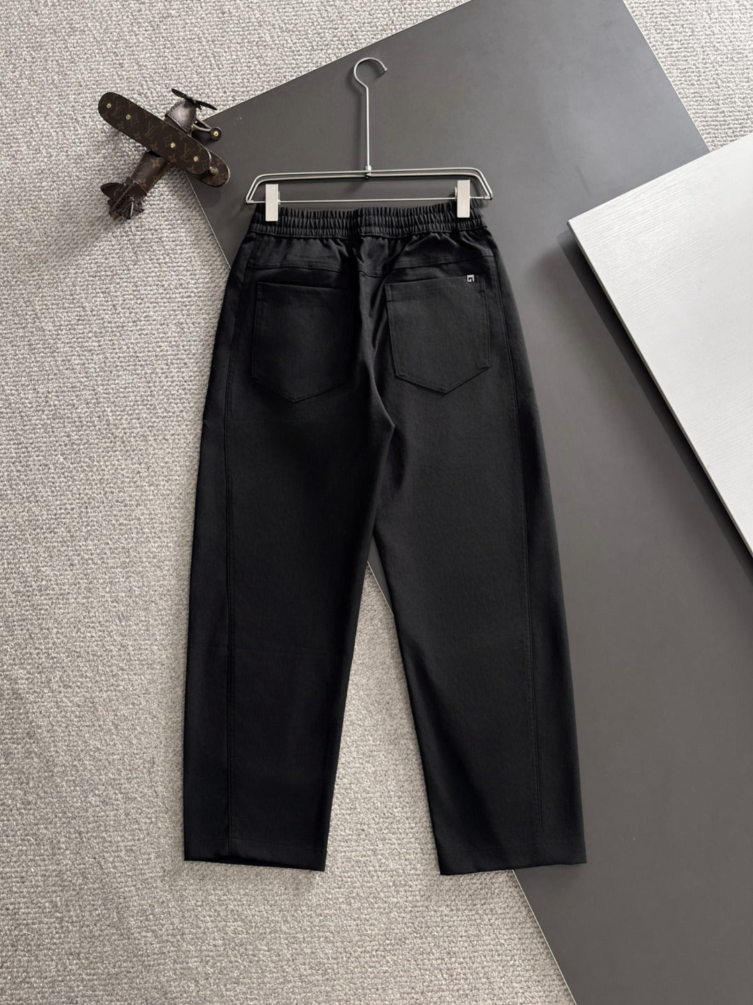 Black Gucci pants with pleated front, elastic waist, and two front pockets