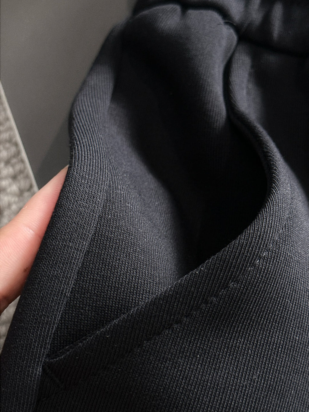Black pants waistband and inner pocket opening with ribbed trim