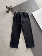 Black pants with elastic waistband, front crease, and side pocket