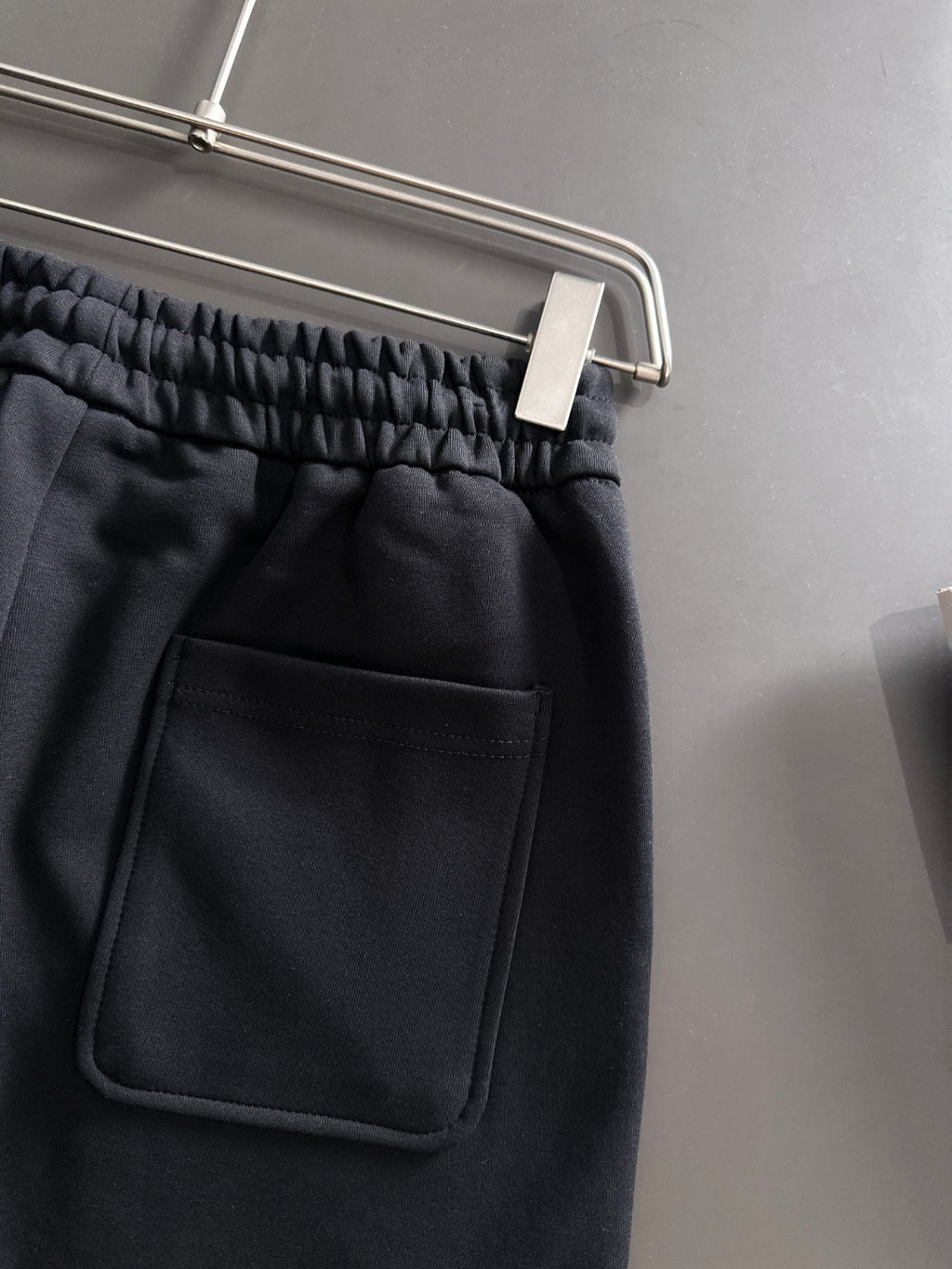 Black pants with elastic waistband and front patch pocket