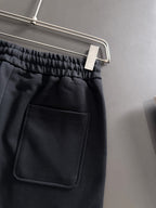 Black pants with elastic waistband and front patch pocket