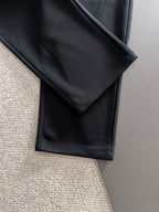 Black straight-leg pants with side seam and stitched fold