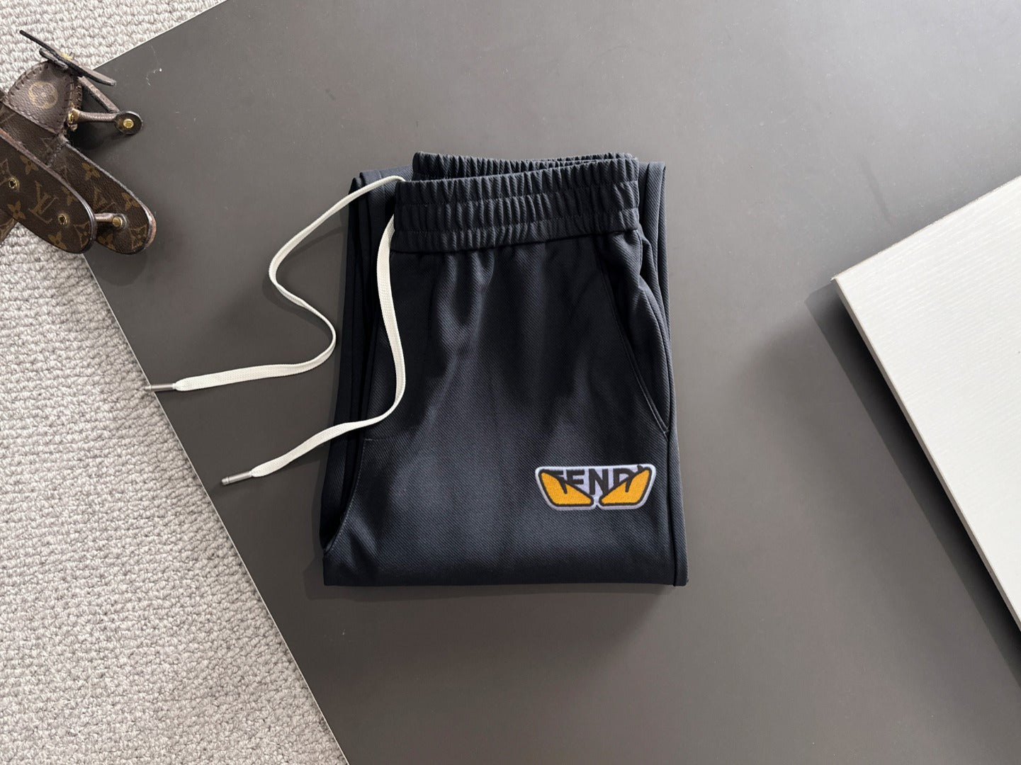 Dark navy pants with elastic waistband and drawstring, small FENDI logo patch