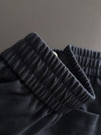 Navy pants fabric detail with textured weave and elastic waistband