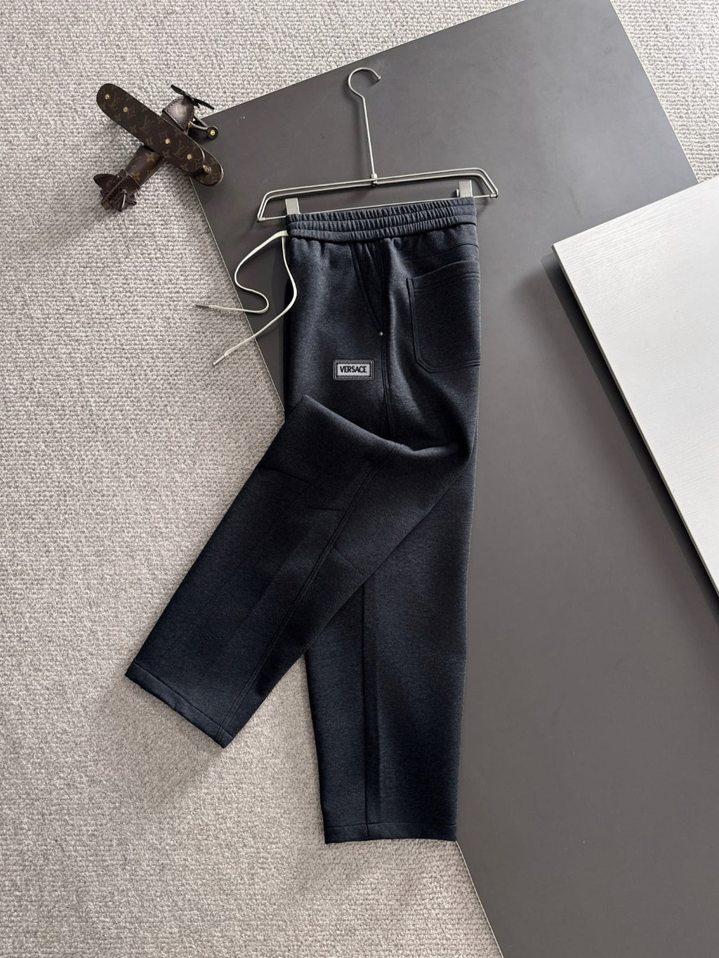 Dark navy jogger pants with drawstring and elastic waistband, Versace logo patch