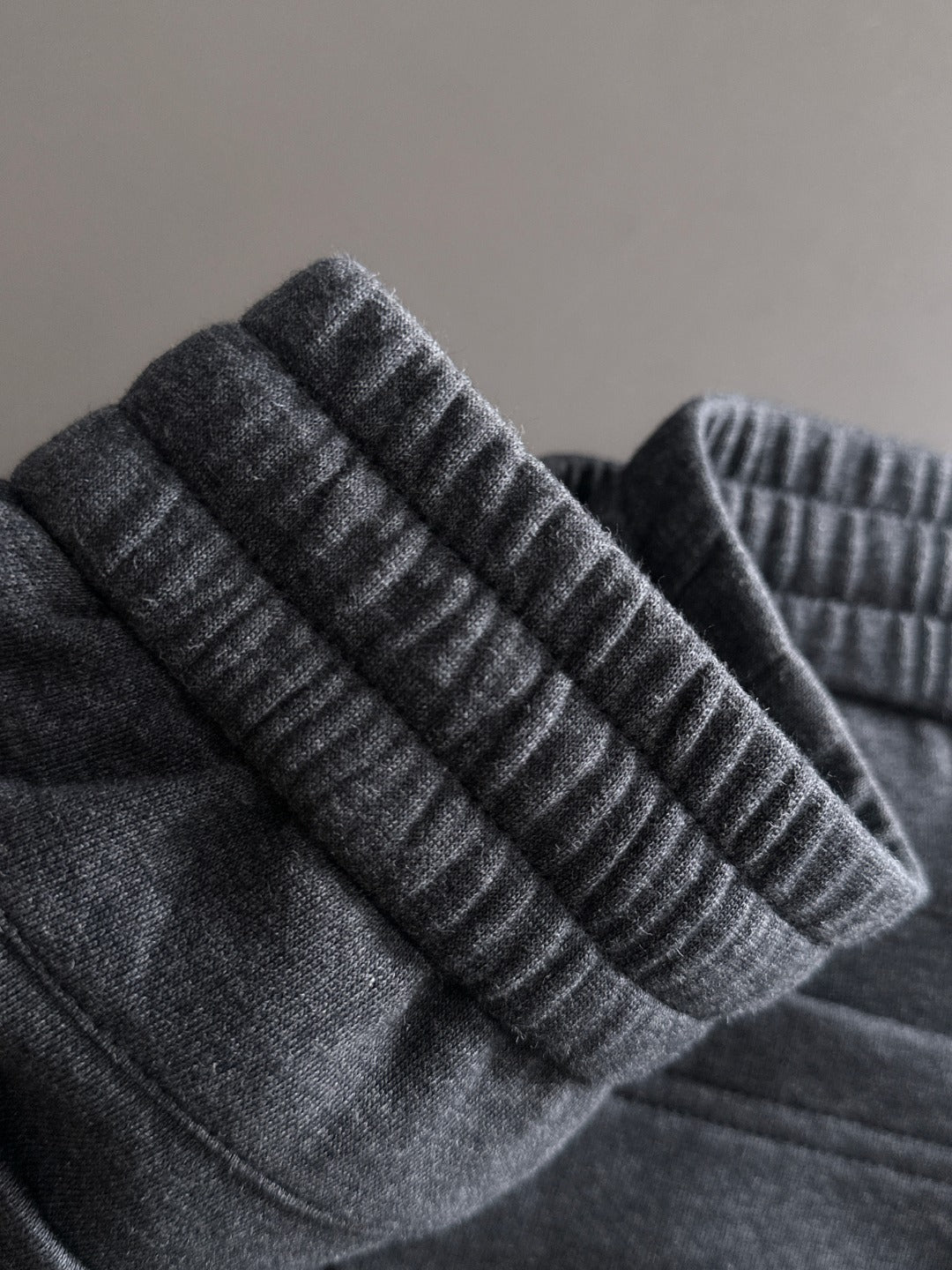 Dark jogger pants ribbed elastic cuffs and textured knit waistband