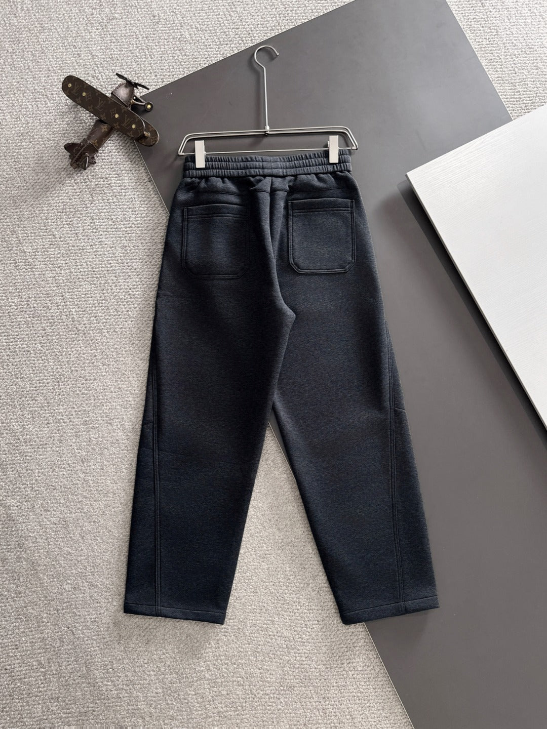 Dark navy jogger pants with two front pockets and elastic drawstring waist