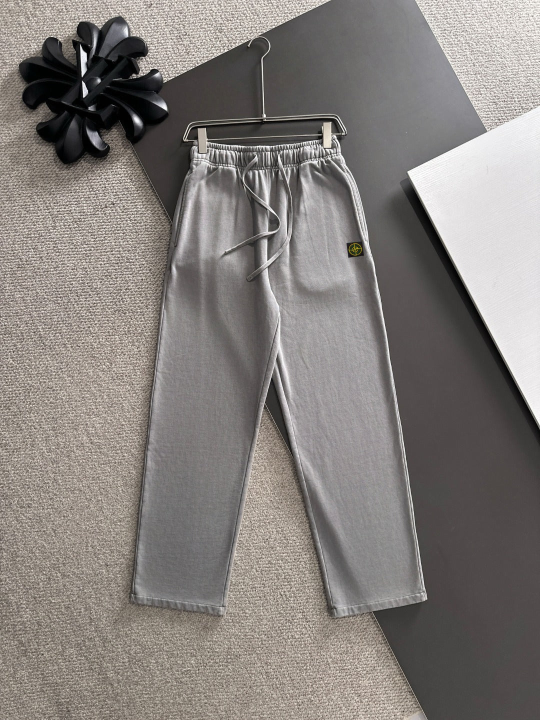 Stone Island light gray sweatpants with elastic waist, drawstring, and side pockets