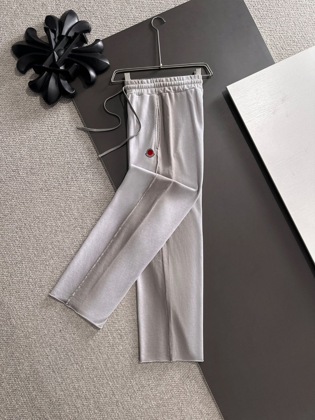 Light gray drawstring pants, long straight legs, Moncler logo patch