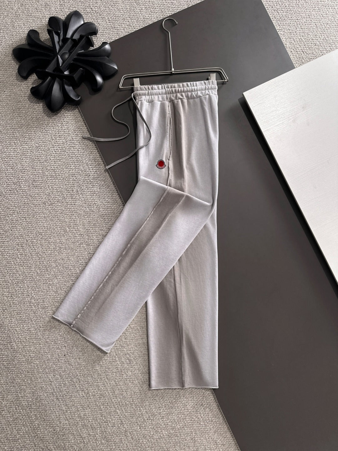 Light gray drawstring pants, long straight legs, Moncler logo patch