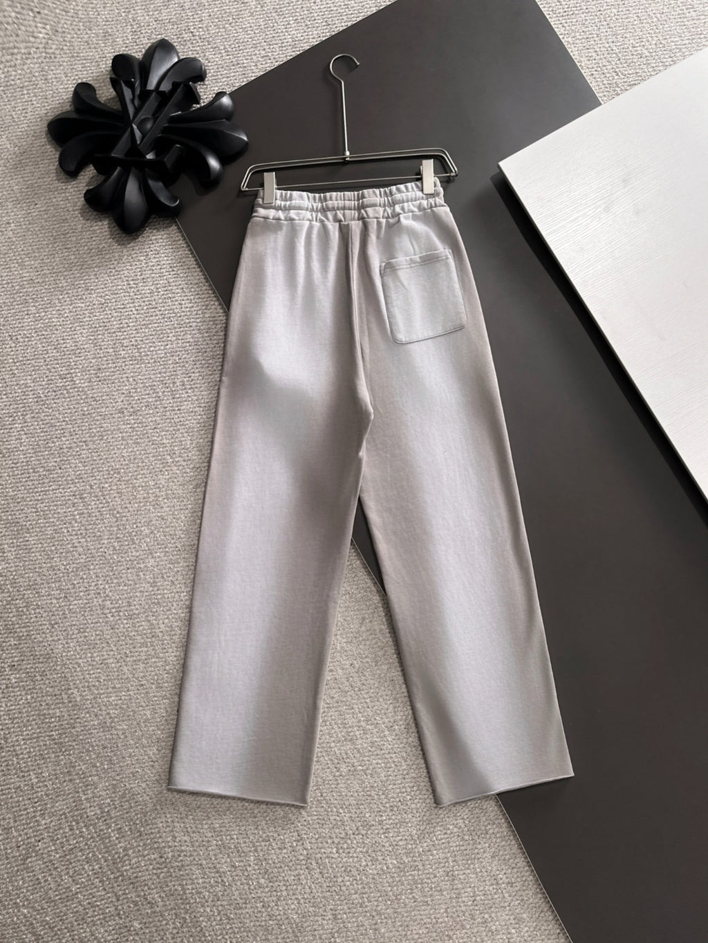 Light gray drawstring pants with elastic waist and front pockets