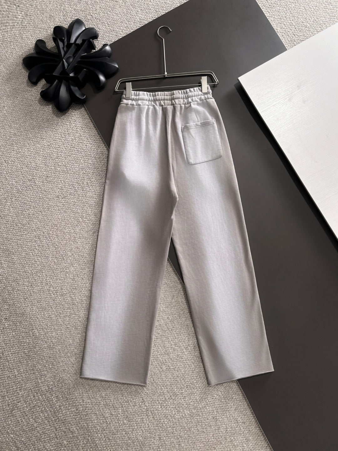 Light gray drawstring pants with elastic waist and front pockets