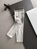 Louis Vuitton pants in white with elastic waistband and multicolor LV logo patch