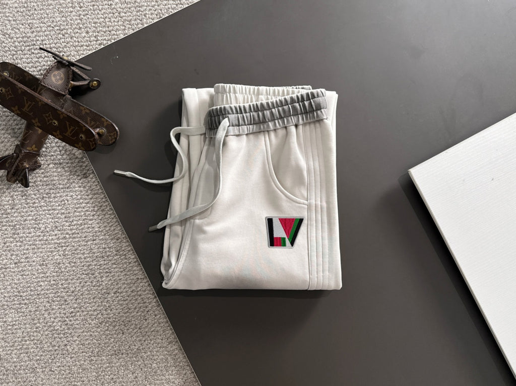Louis Vuitton pants folded in white with elastic waistband and multicolor LV logo patch