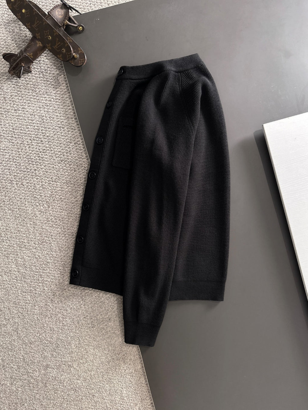 Black cardigan jacket with long sleeves and button front
