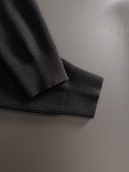 Black cardigan cuff and hem in ribbed knit