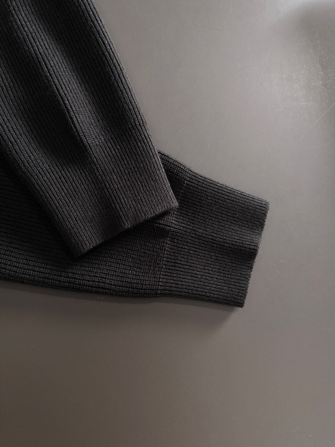 Black cardigan cuff and hem in ribbed knit
