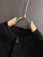 Black cardigan neckline with round button detail