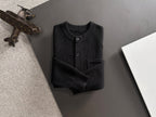 Black cardigan top with long sleeves and front buttons