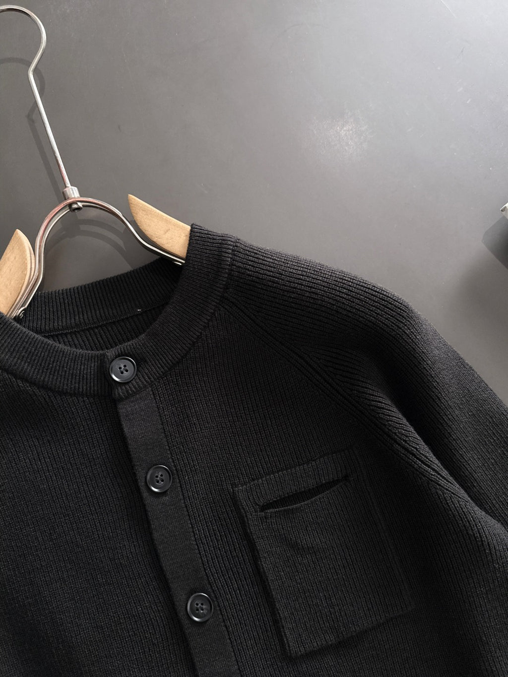 Black ribbed cardigan with round buttons and chest pocket