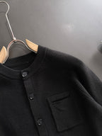 Black ribbed cardigan with round buttons and chest pocket