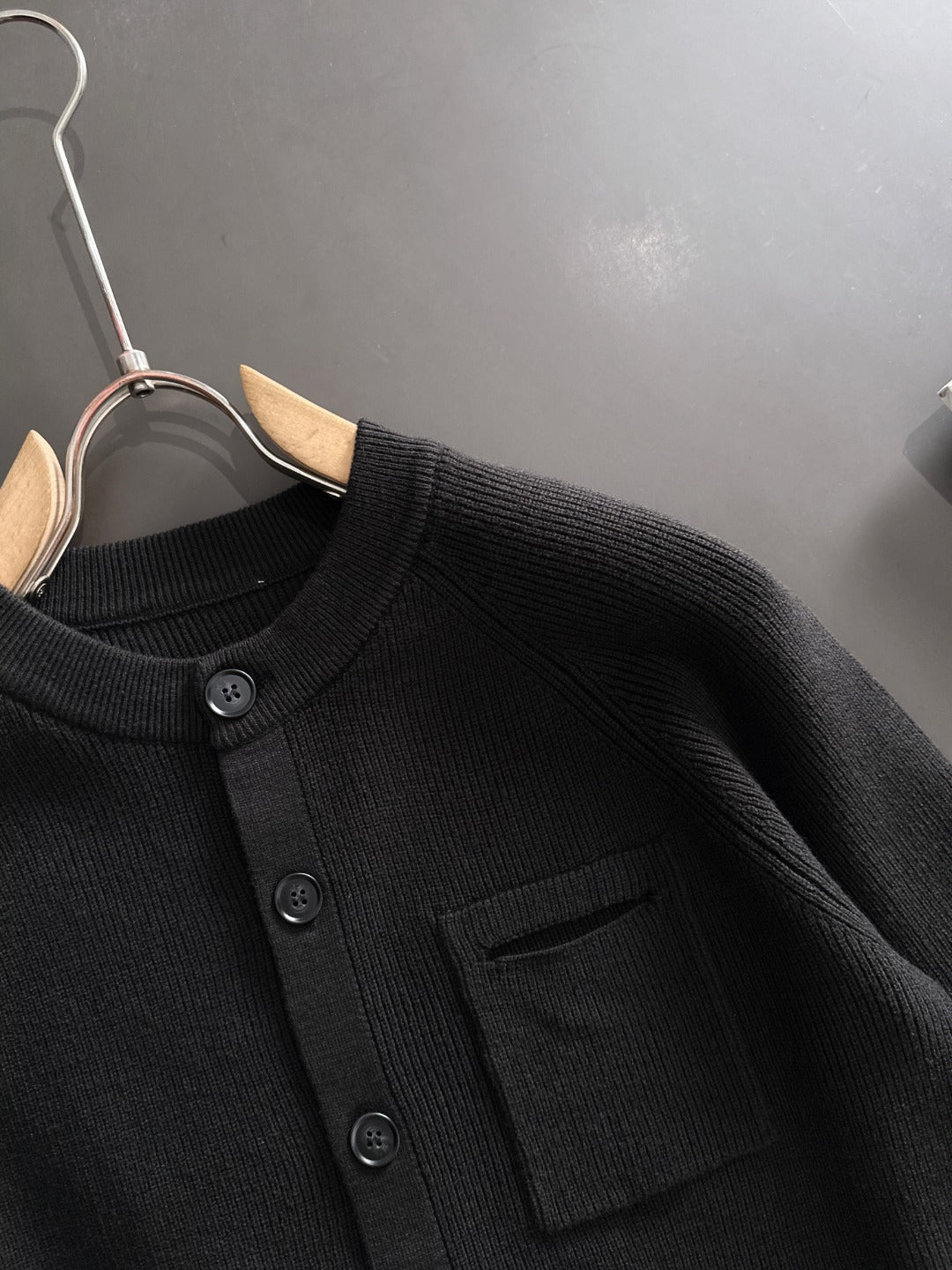Black ribbed cardigan with round buttons and chest pocket