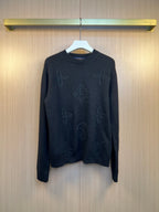 Dark knit sweater with embroidered monogram pattern