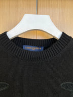 Dark knit sweater neckline with Louis Vuitton logo patch