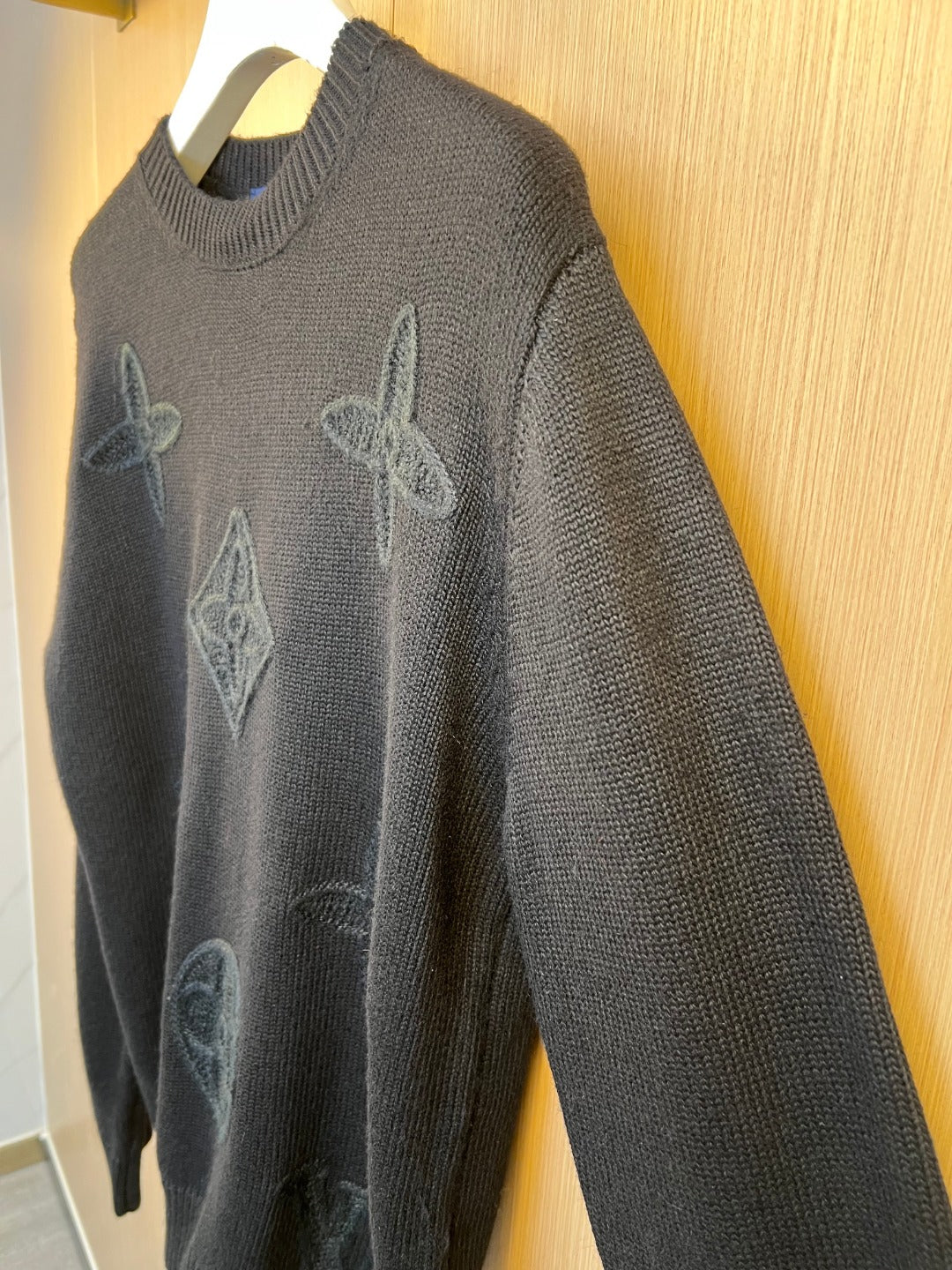 Charcoal knit sweater with embroidered rabbit monogram pattern
