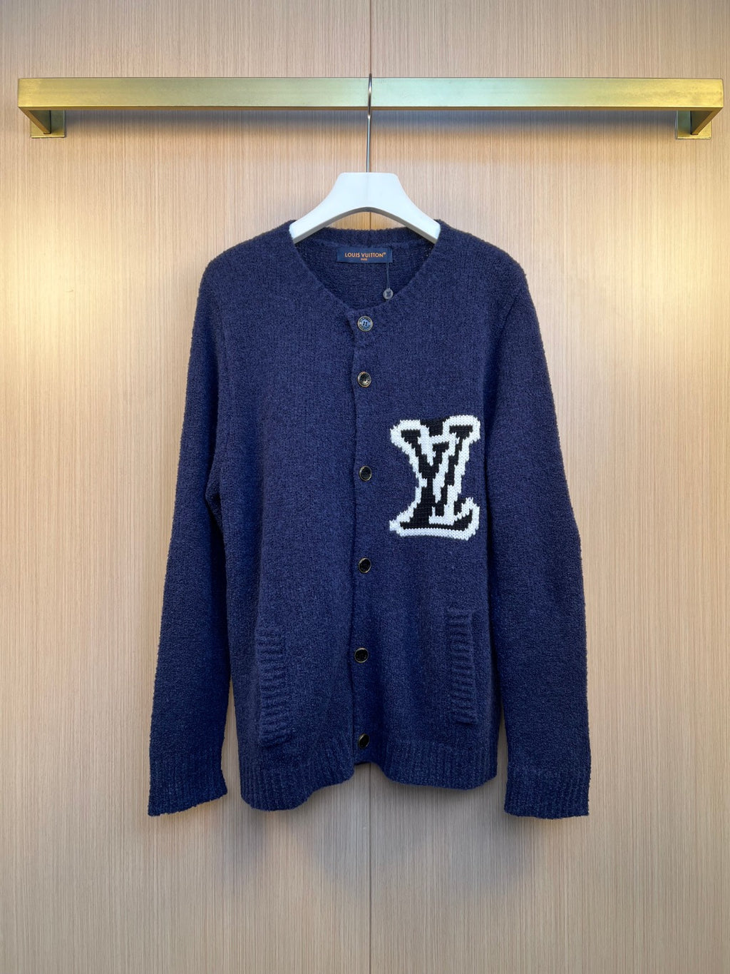 Louis Vuitton navy knit cardigan with button front and white LV-style logo patch