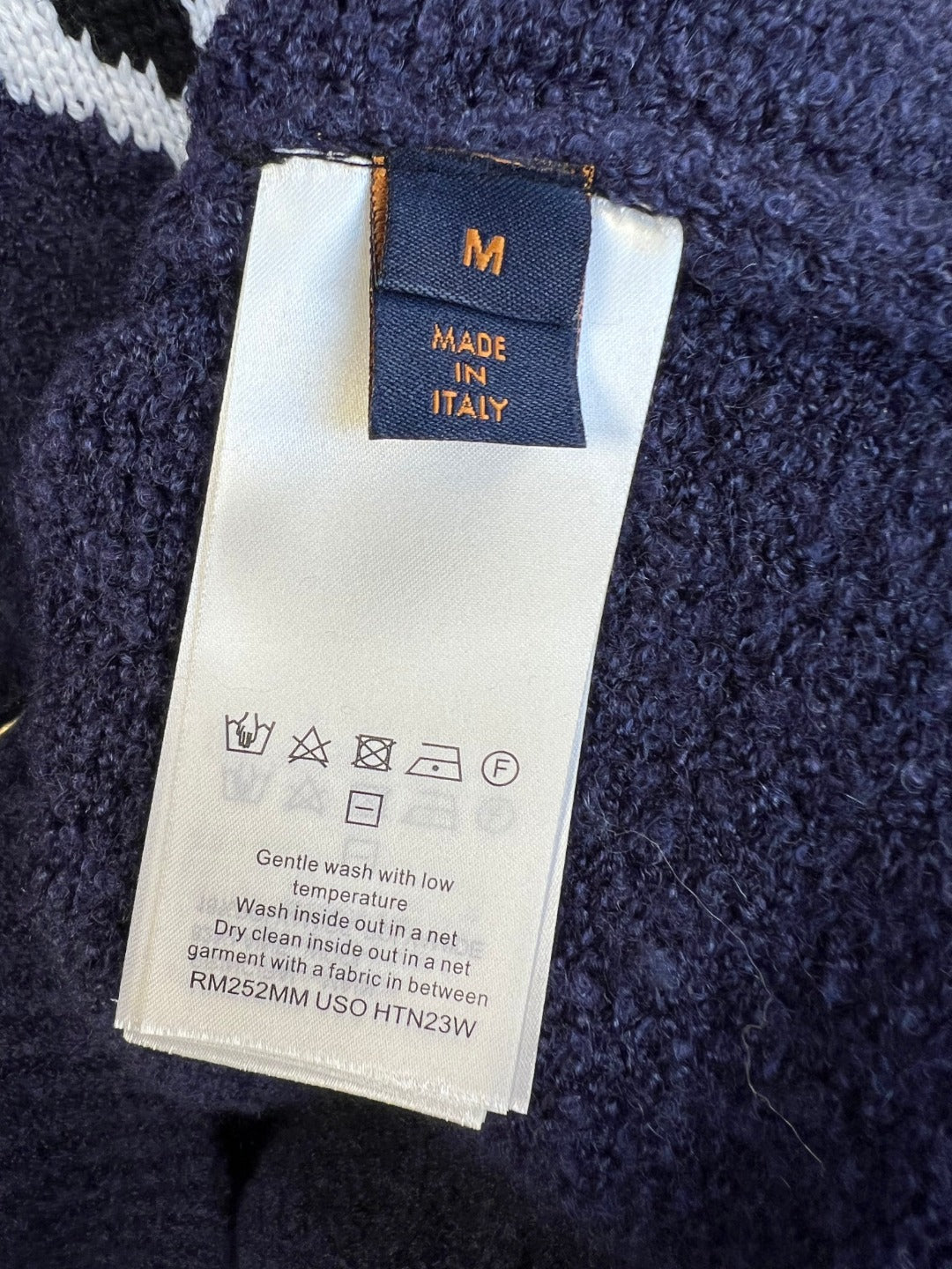 Louis Vuitton size M care label on navy knit cardigan with buttons