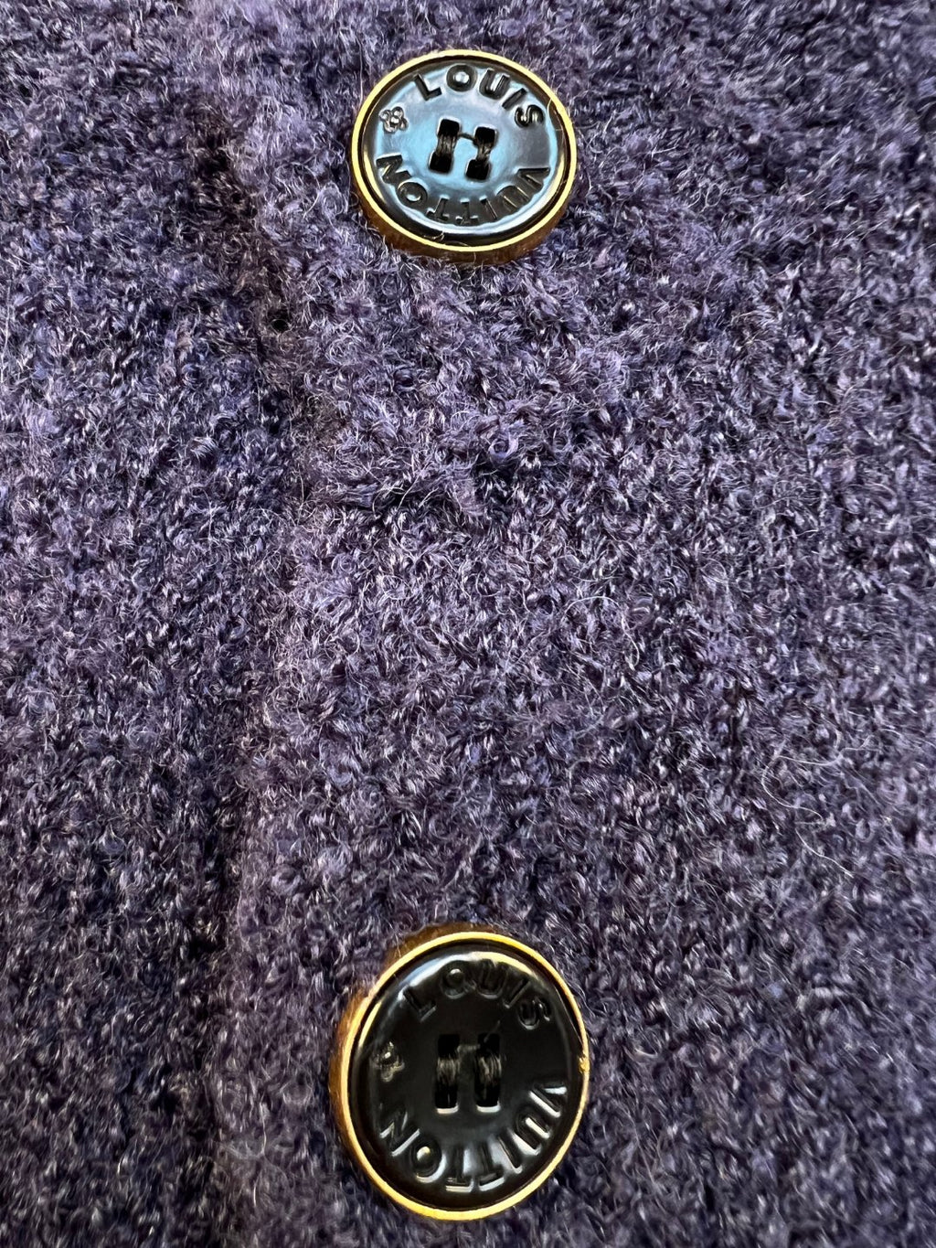 Navy knit cardigan gold-tone button close-up with embossed emblem