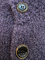 Navy knit cardigan gold-tone button close-up with embossed emblem