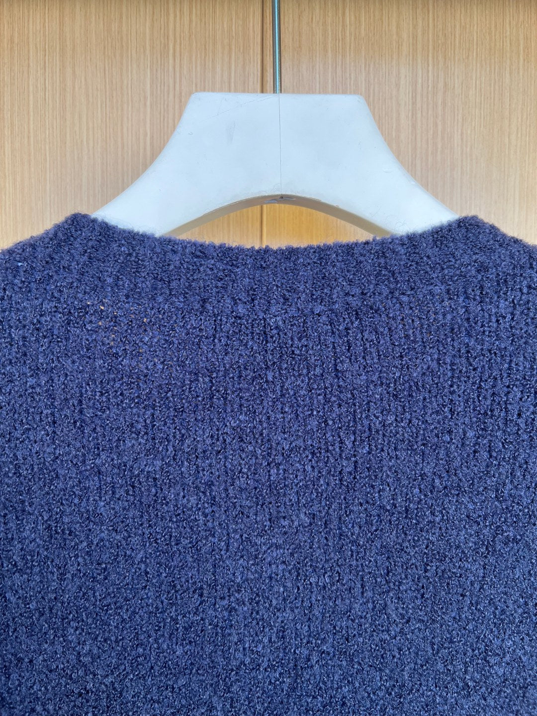 Navy knit cardigan back close-up with textured fabric