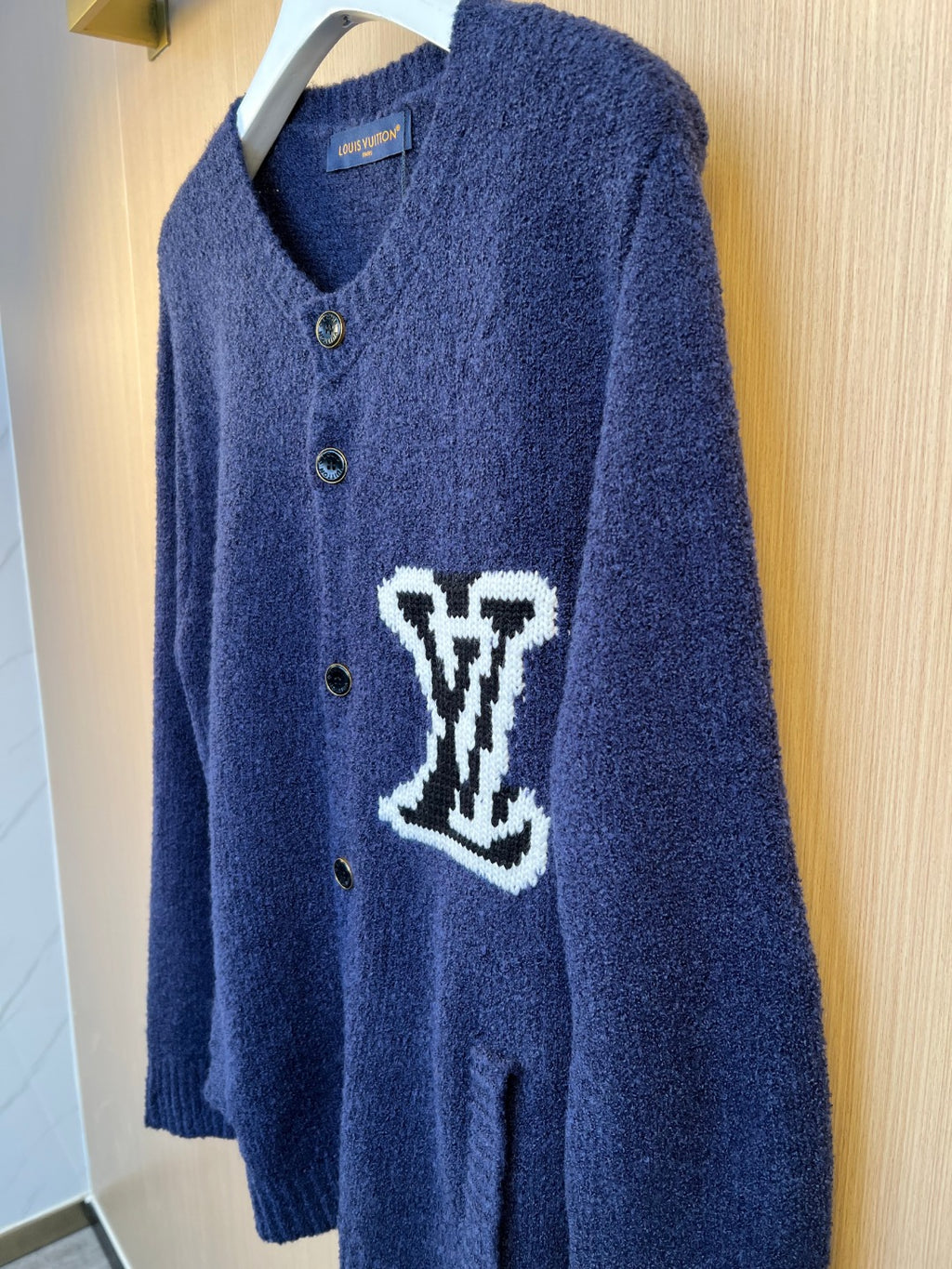 Navy Louis Vuitton knit cardigan front with button placket and white LV-style logo