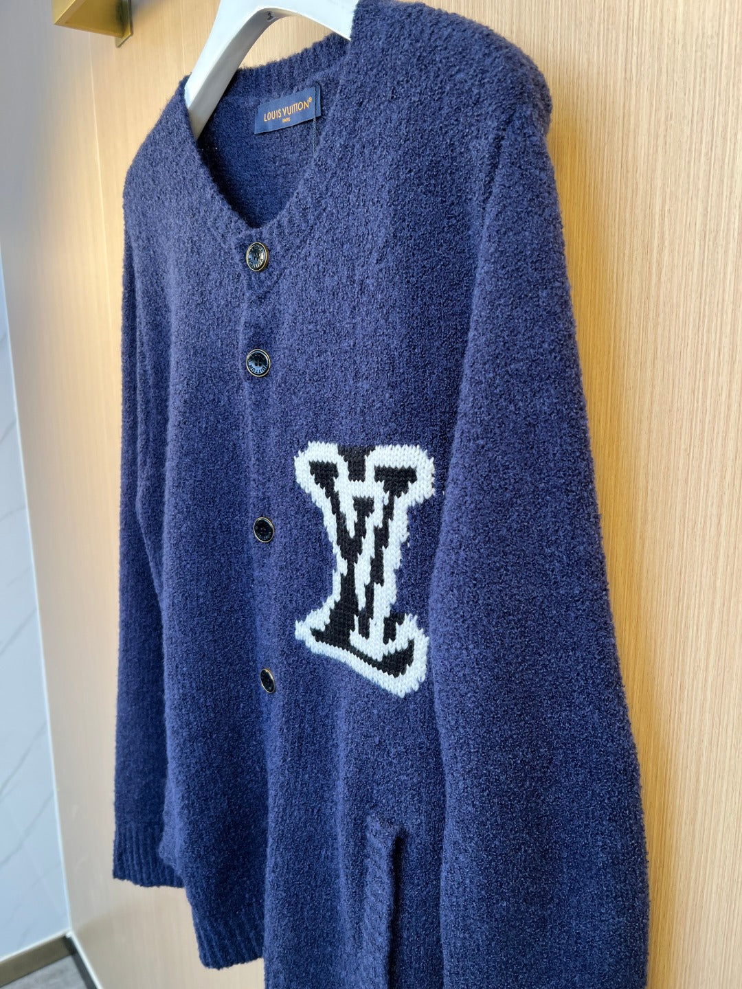 Navy Louis Vuitton knit cardigan front with button placket and white LV-style logo