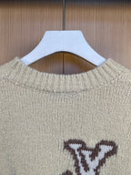 Light cream knit sweater neckline with ribbing and partial LV monogram, close-up