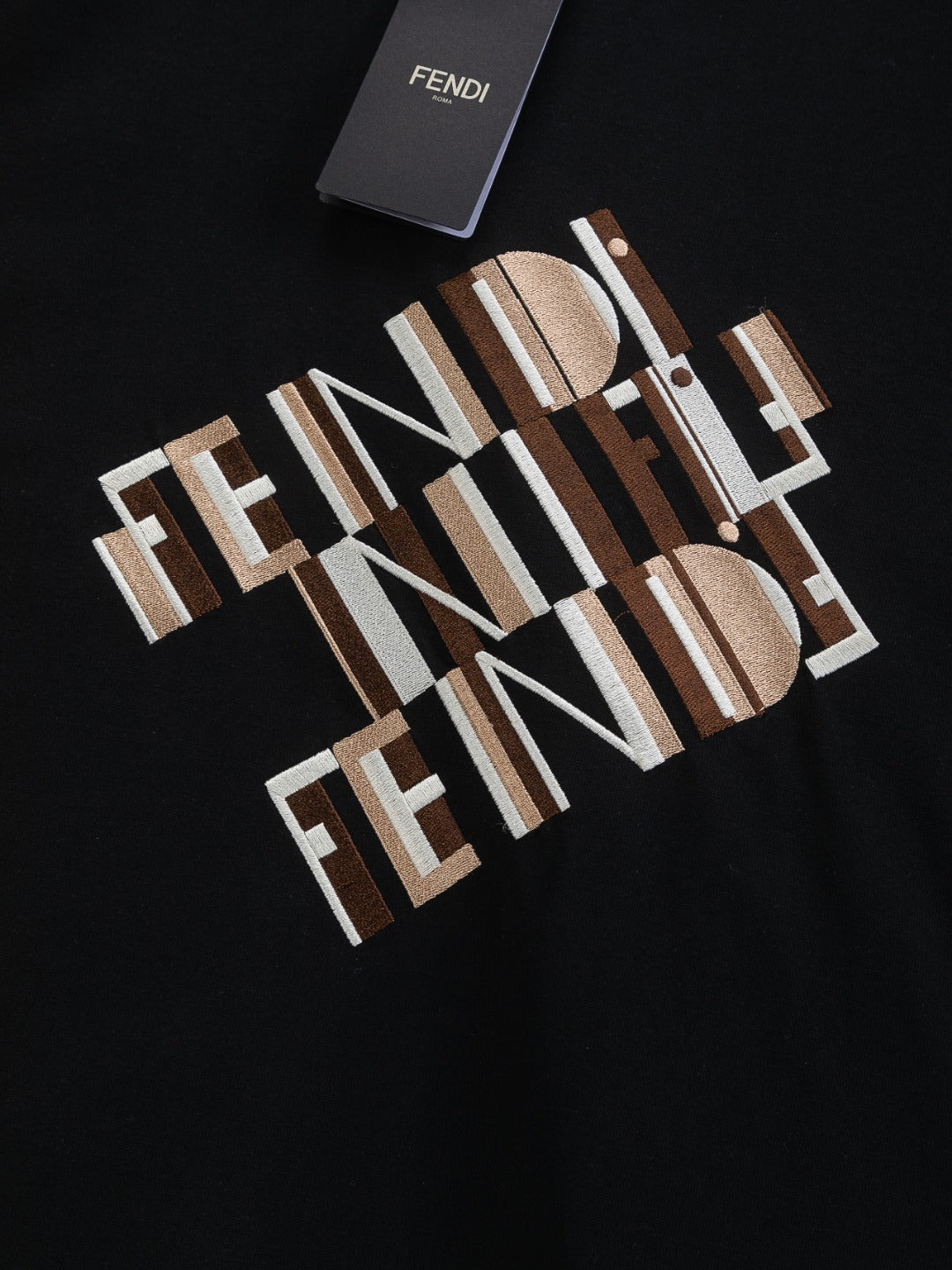 Close-up of black Fendi short-sleeve T-shirt with oversized FENDI lettering