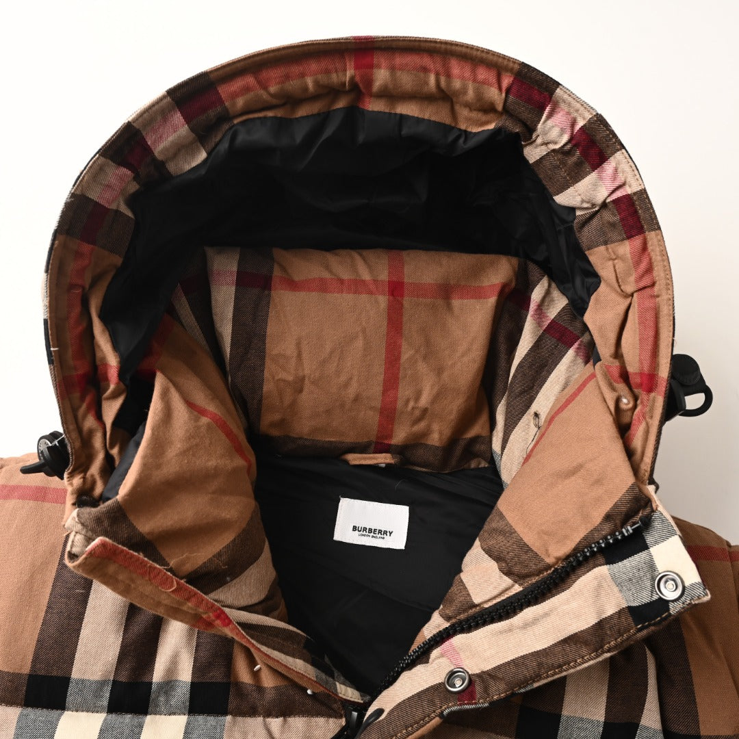 Plaid hood lining with black inner panel inside long quilted jacket