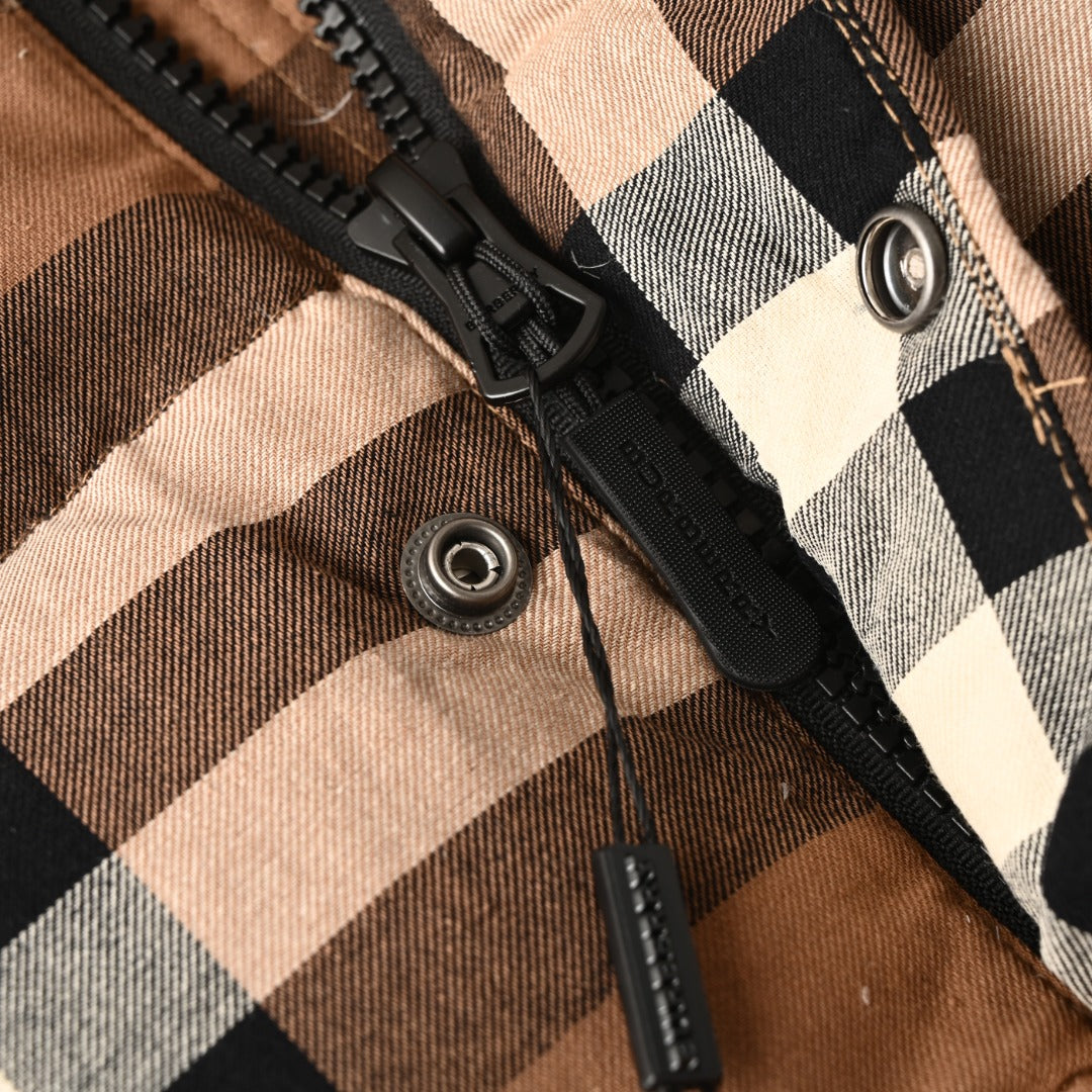 Plaid front placket with black zipper and metal snap buttons
