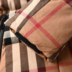 Plaid sleeve cuff with black elastic trim on long quilted jacket