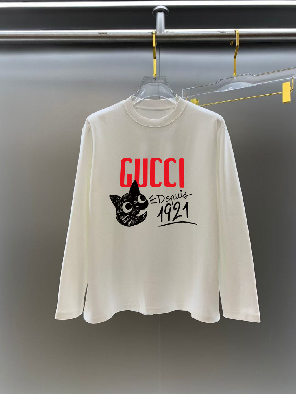 White long-sleeve crewneck T-shirt with red GUCCI logo and black cat graphic