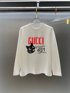 White long-sleeve crewneck T-shirt with red GUCCI logo and black cat graphic
